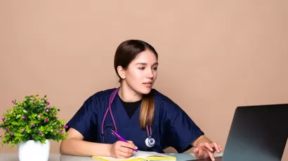 med student working on a laptop