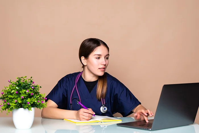 med student working on a laptop