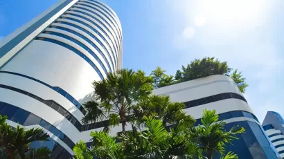 Palm trees, blue sky, modern academic building