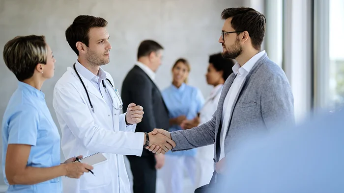 Medical students networking with alumni and mentors at a career event